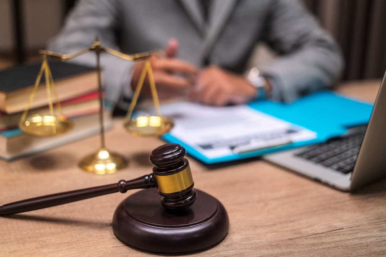 lawyer gavel on the table and sitting and reading 