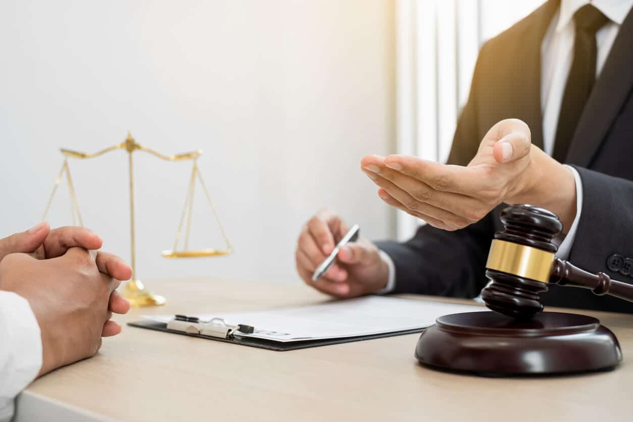 Big Creek Lawyer with gavel and scales of justice, discussing a personal injury case with a client.
