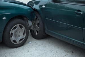 Two cars involved in a collision on a roadway, illustrating a California car accident potentially caused by unsafe or poorly maintained road conditions.